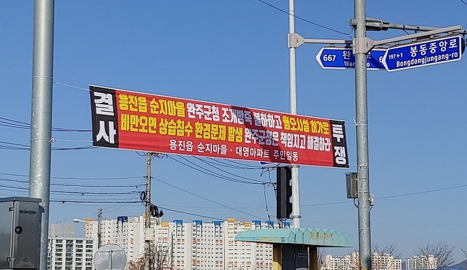 봉동교 입구에 1일 게재된 현수막. 대영아파트 주민들 동의 없이 게재돼 4일 오전에 철거됐다.